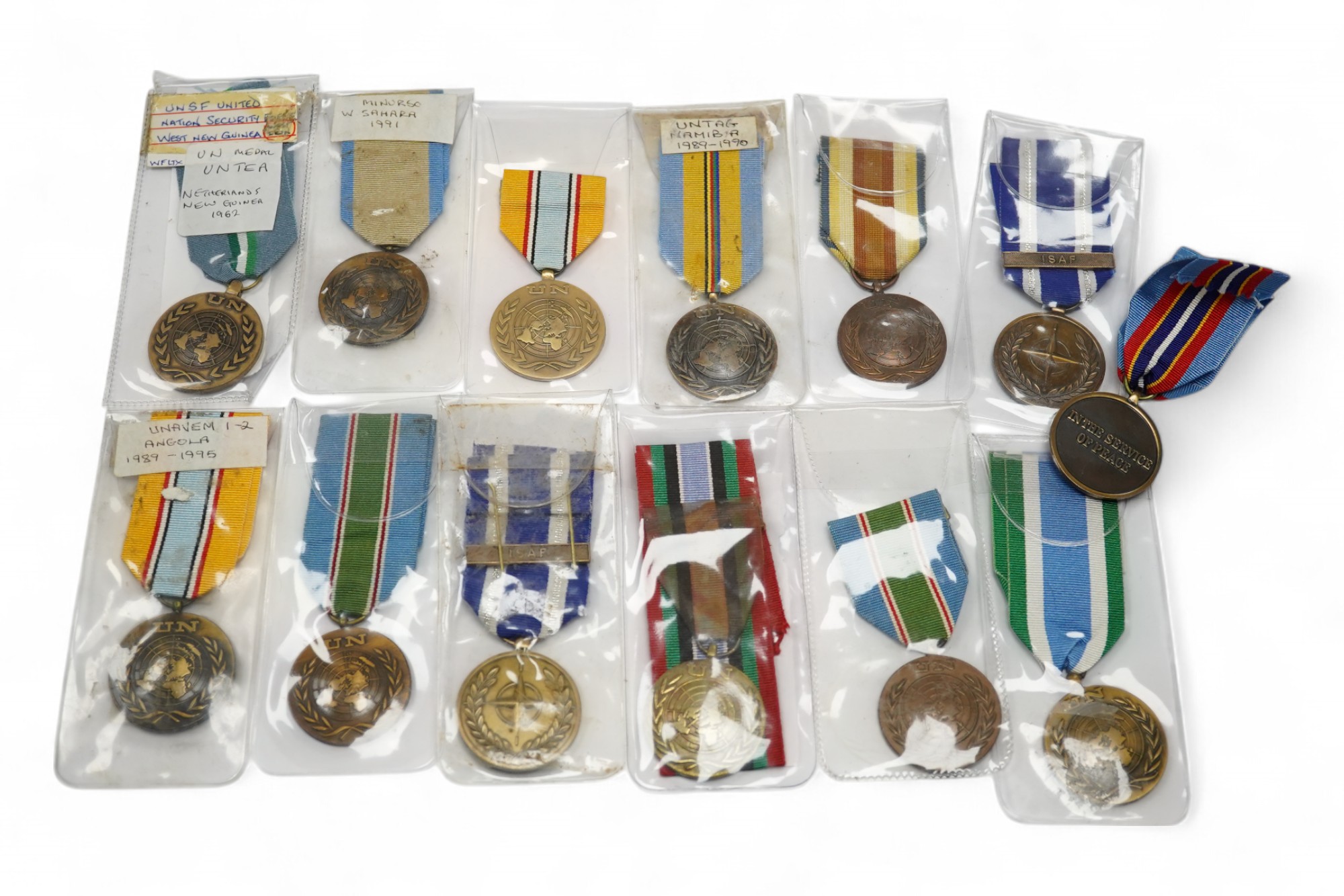 Thirteen United Nations (UN) and NATO medals, eleven UN examples with ‘ in the service of peace’ to the reverse, including a variety of ribbons for a number of different campaigns, (some duplicates), and two NATO ISAF Af